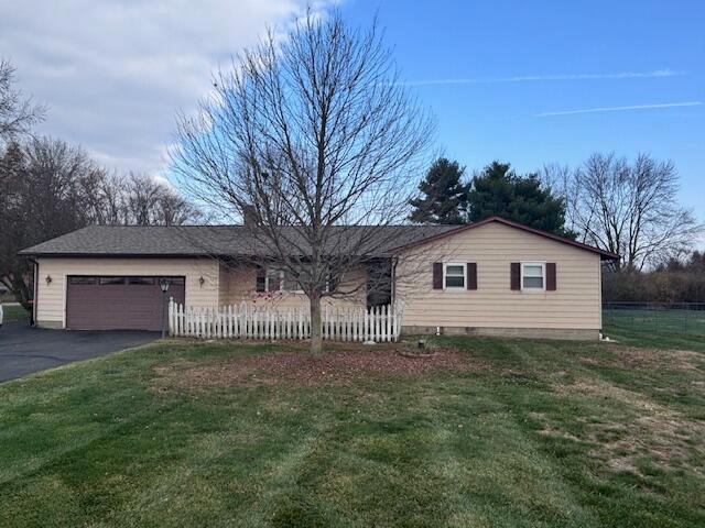 single story home with a front yard and a garage