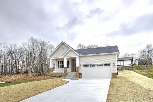 craftsman house with a porch, a garage, and a front lawn