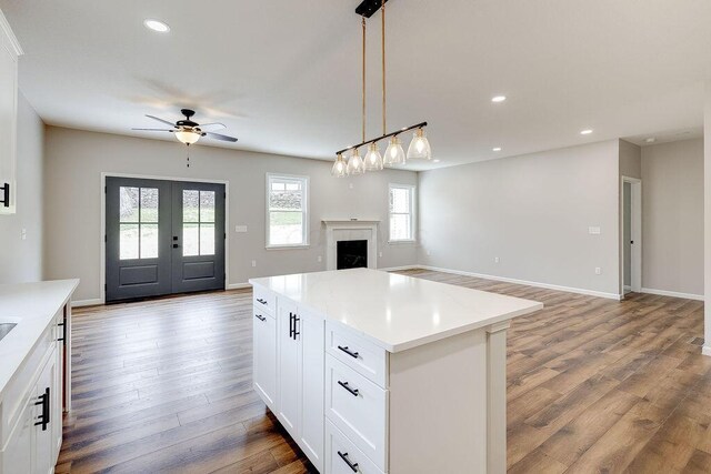 kitchen with open floor plan, wood finished floors, ceiling fan, and recessed lighting