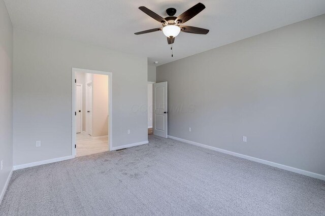 unfurnished bedroom featuring baseboards, ceiling fan, and light colored carpet