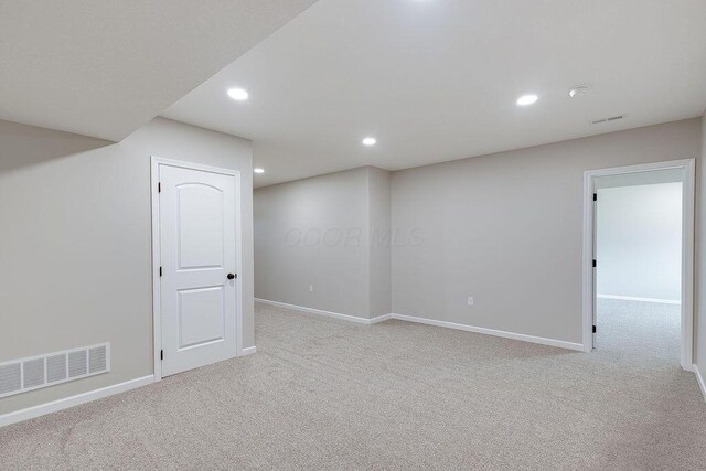 basement featuring carpet flooring, baseboards, visible vents, and recessed lighting