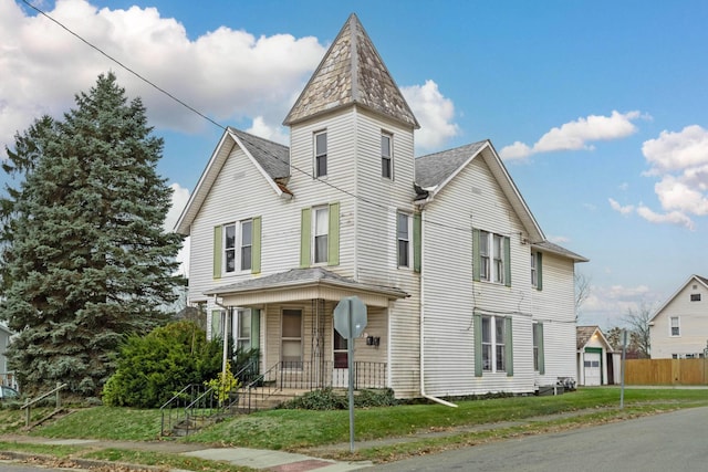 victorian home with a front yard and covered porch