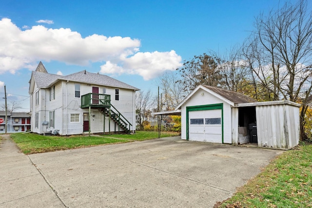 exterior space featuring a lawn, an outdoor structure, and a garage