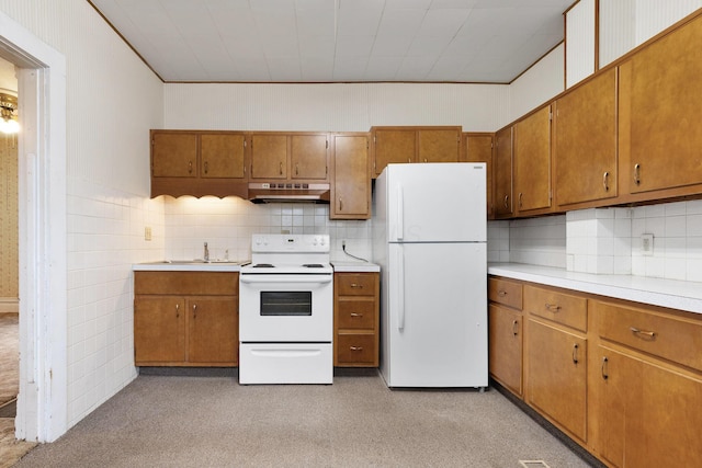 kitchen featuring decorative backsplash, sink, light colored carpet, and white appliances