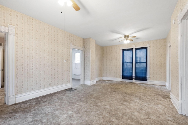 carpeted empty room featuring ceiling fan