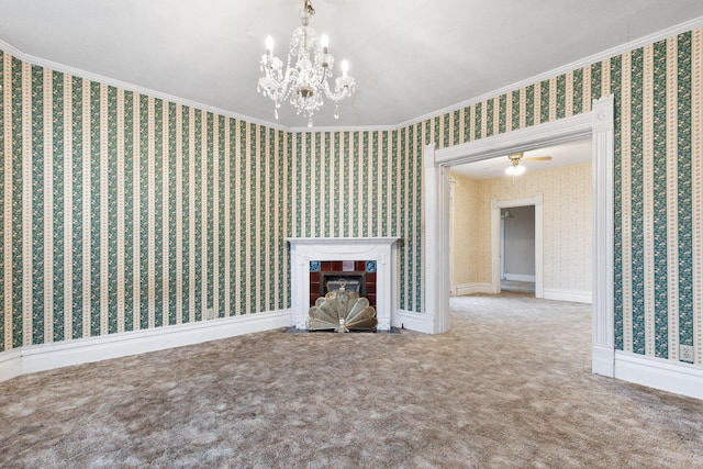 unfurnished living room with carpet, ceiling fan with notable chandelier, ornamental molding, and a tile fireplace