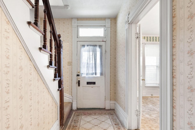 doorway to outside with light colored carpet