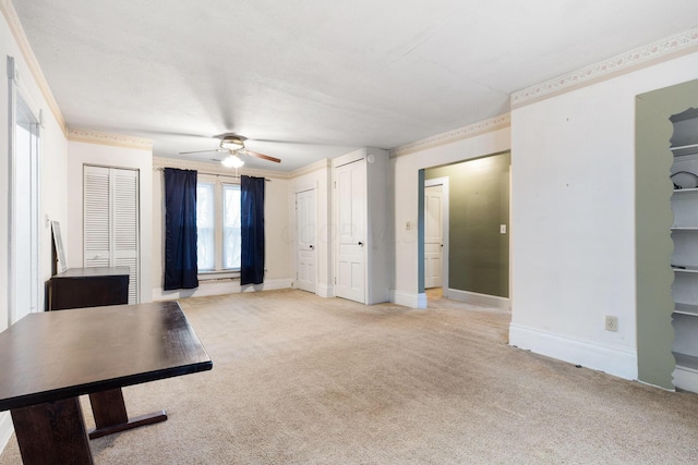 unfurnished living room featuring light carpet, ceiling fan, and crown molding