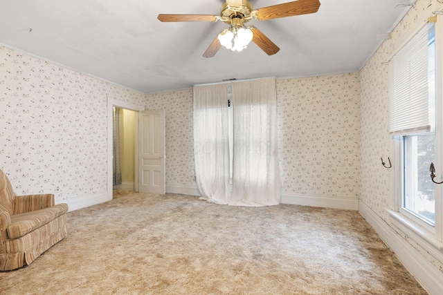 unfurnished room with carpet flooring, ceiling fan, and ornamental molding