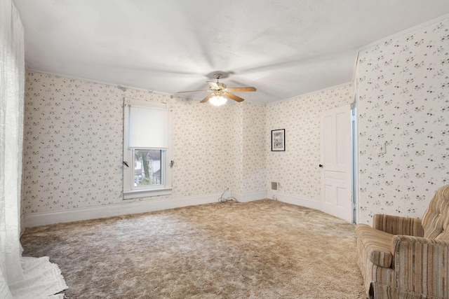 interior space with ceiling fan and ornamental molding