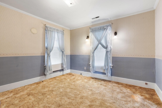 carpeted empty room featuring crown molding