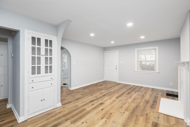 unfurnished living room with light hardwood / wood-style flooring