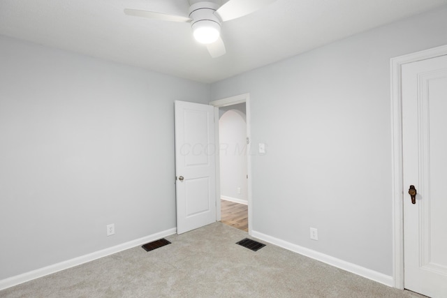 interior space featuring ceiling fan and light colored carpet