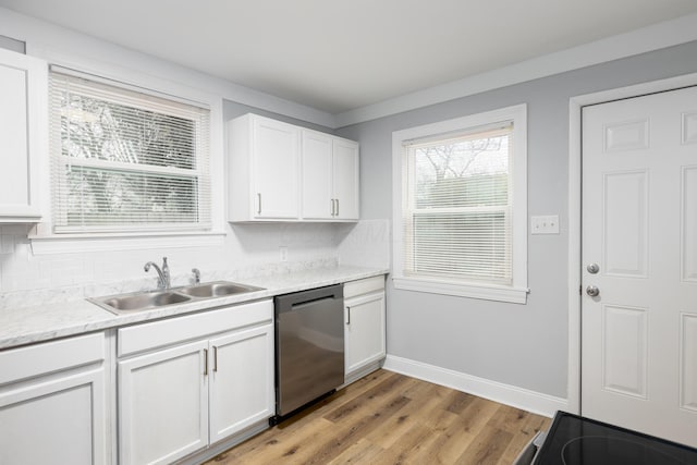 kitchen with white cabinets, dishwasher, sink, and light hardwood / wood-style flooring