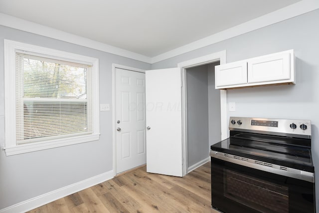 kitchen with white cabinets, stainless steel range with electric cooktop, and light hardwood / wood-style floors