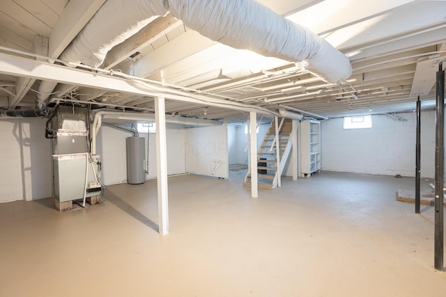 basement featuring gas water heater and heating unit