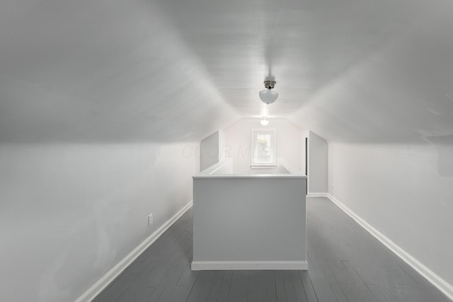 bonus room with dark wood-type flooring and lofted ceiling