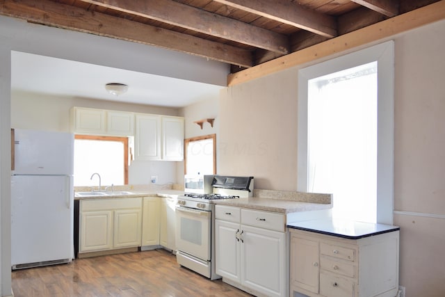 kitchen with sink, white appliances, wooden ceiling, beam ceiling, and light hardwood / wood-style flooring