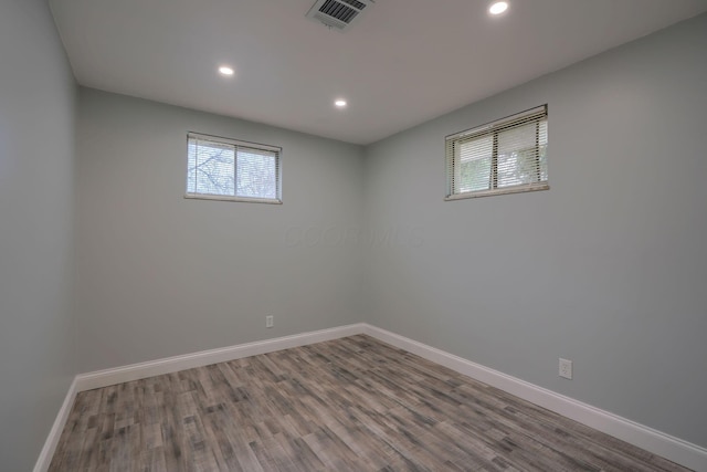 unfurnished room with wood-type flooring