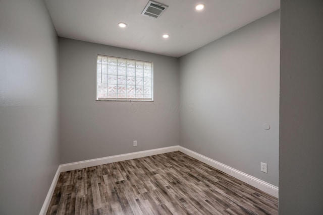 spare room with hardwood / wood-style flooring