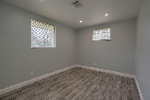 empty room with hardwood / wood-style floors