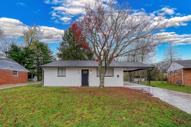 view of front of property with a front lawn and a carport