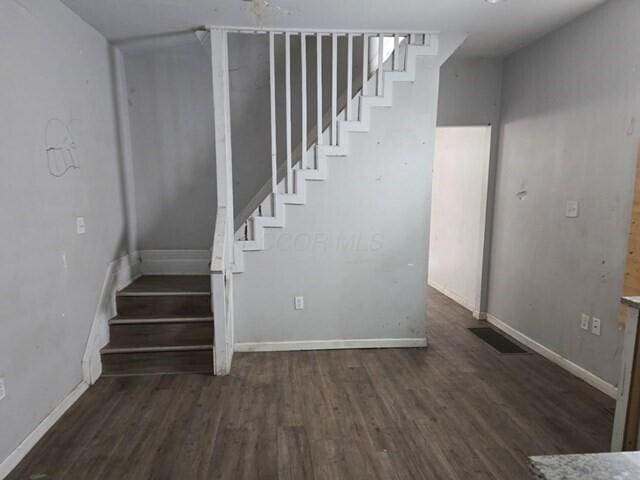 stairway featuring hardwood / wood-style floors