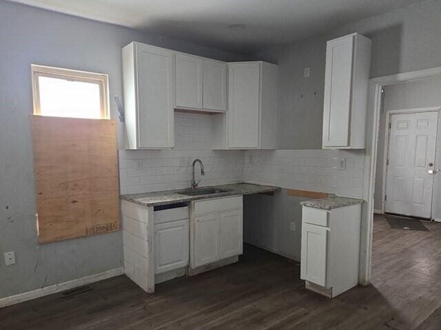 kitchen featuring white cabinets, dark hardwood / wood-style floors, backsplash, and sink