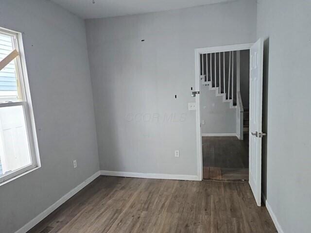 spare room featuring dark wood-type flooring