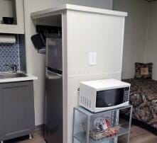 interior space with decorative backsplash, stainless steel fridge, and sink