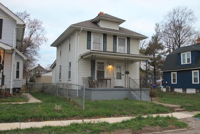 view of front of home with covered porch and a front yard