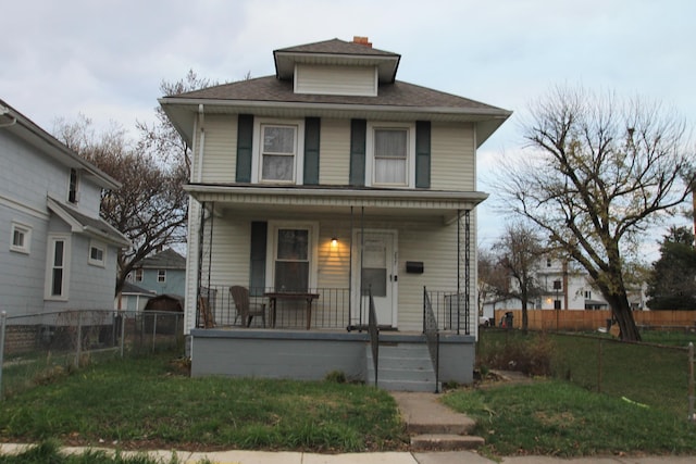 front of property featuring covered porch and a front yard