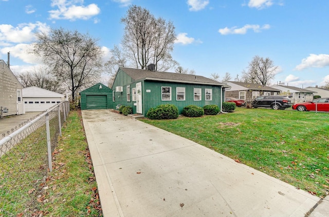 view of front of house featuring a front yard, a garage, and an outdoor structure