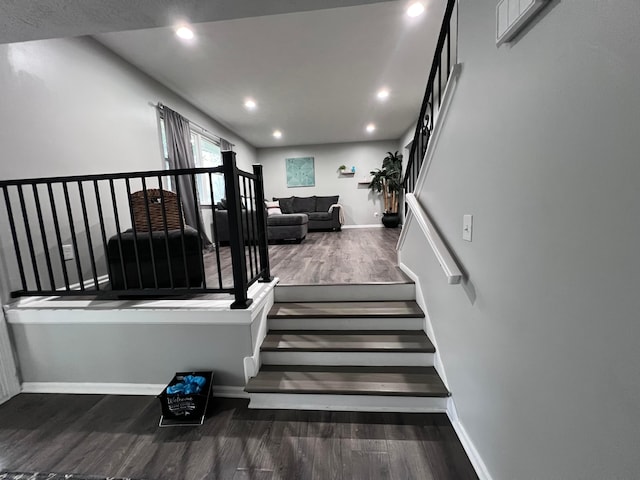 stairs with hardwood / wood-style floors