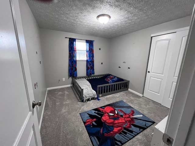 carpeted bedroom with a textured ceiling