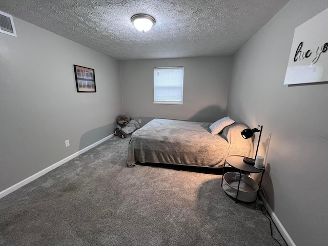 bedroom featuring carpet and a textured ceiling