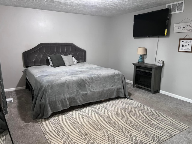 carpeted bedroom featuring a textured ceiling