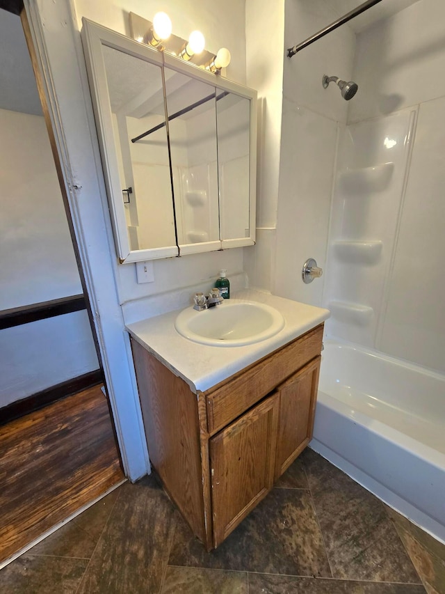 bathroom with washtub / shower combination, wood-type flooring, and vanity