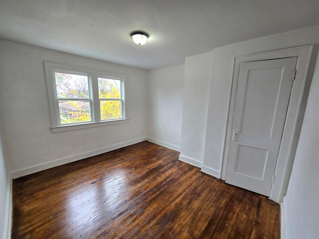 spare room featuring dark hardwood / wood-style floors