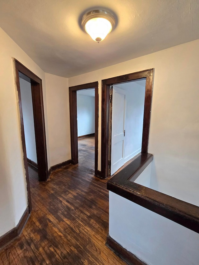 corridor with dark hardwood / wood-style floors