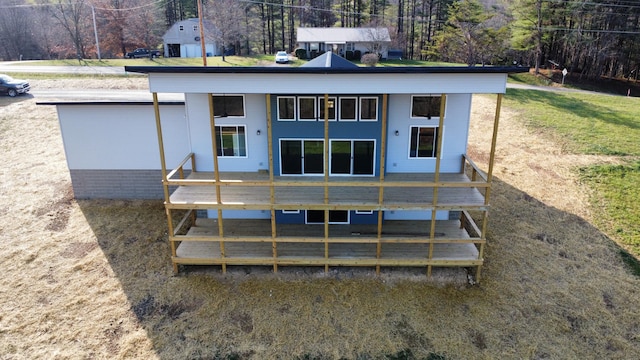 rear view of property with a wooden deck