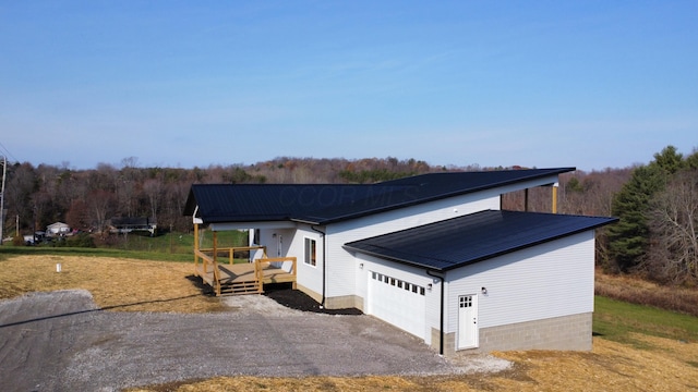 exterior space with a wooden deck and a garage