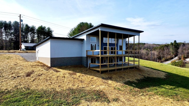 rear view of property with a lawn