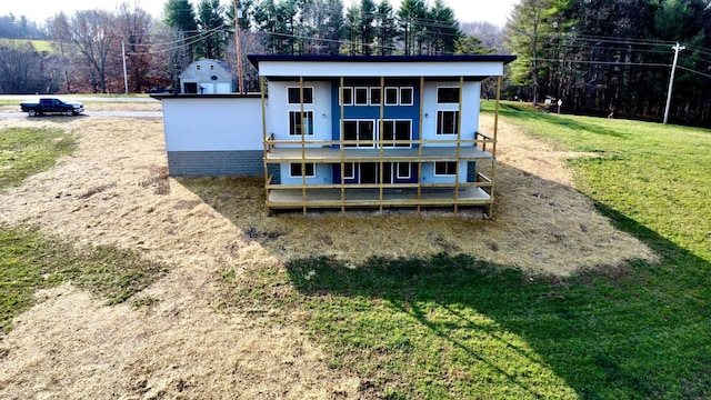 rear view of property featuring a yard