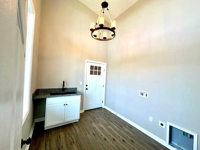 clothes washing area with sink, cabinets, hookup for an electric dryer, dark hardwood / wood-style flooring, and a chandelier