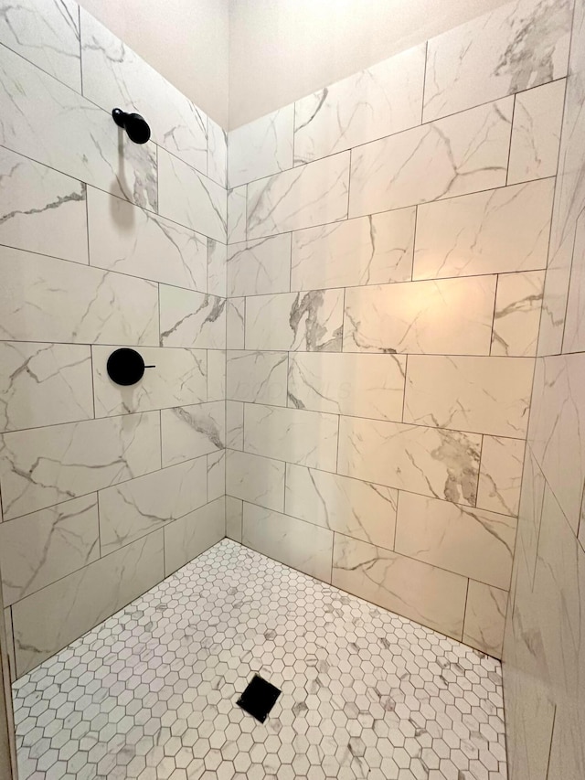 bathroom with a tile shower