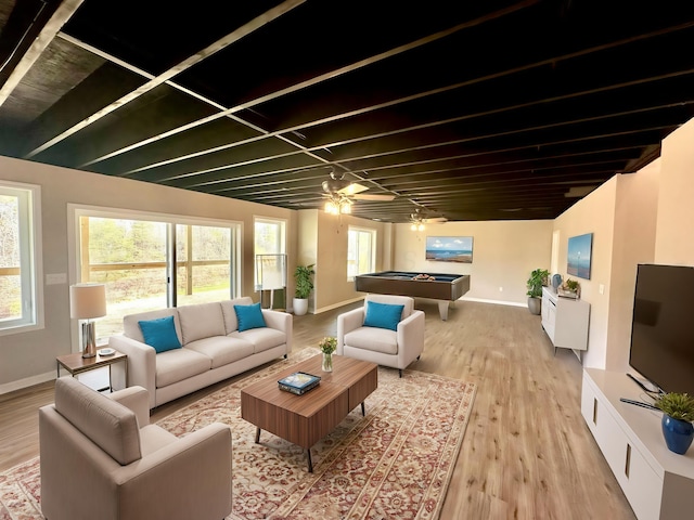 living room featuring ceiling fan and light hardwood / wood-style flooring