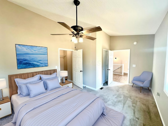 bedroom with ceiling fan, carpet floors, and lofted ceiling