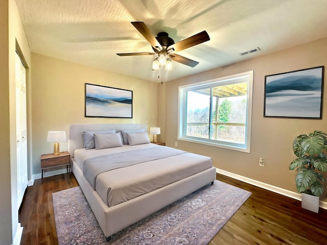 bedroom with ceiling fan, dark hardwood / wood-style flooring, and a closet