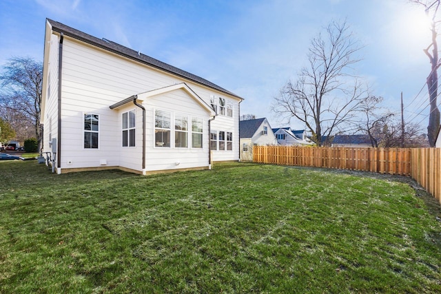 rear view of house with a lawn